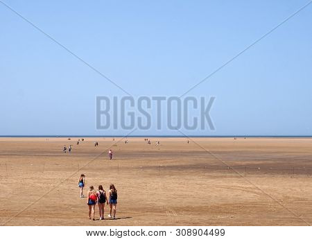 Southport, Merseyside, United Kingdom - 28 June 2019: A Group Of Young Women Walking Onto The Long B
