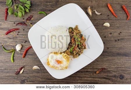 Spicy Thai Basil With Crispy Chicken And Egg (pad Krapow Gai) On Table . It Is A Very Delicious Thai