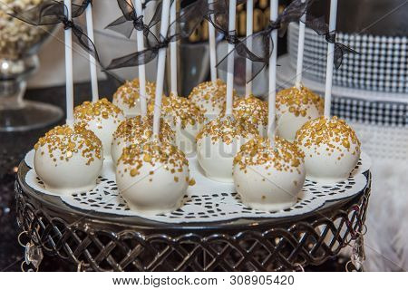 White Frosted Cake Pops Arranged On Platform And Ready For Party Goer To Eat Delicious Dessert..