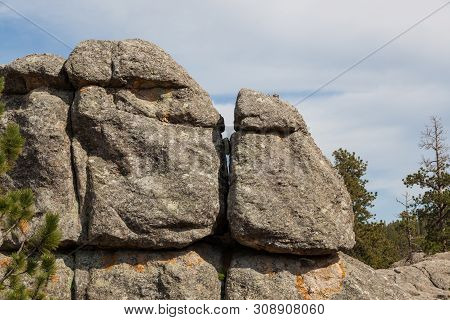 Large Granite Rock Formations And Trees Along The Shoreline Of  Sylvan Lake In South Dakota.