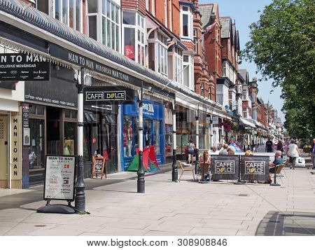 Southport, Merseyside, United Kingdom - 28 June 2019: People Sitting At Outdoor Cafes And Walking Pa