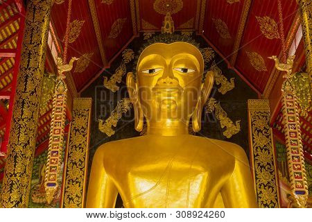 Chiang Ray, Thailand - December 17, 2018: Head Of A Giant Buddha Statue Close Up. Vihan Buddhist Tem
