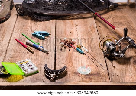 Fishing Hooks, Baits And Tools For Fishing. Fishing Tackle On A Wooden Jetty.
