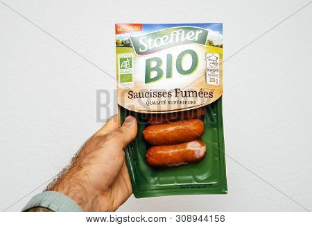 Paris, France - Jun 5, 2019: Man Hand Holding Stoeffler Bio Saucisses Fumees Superior Quality French