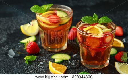 Refreshing Pimms Cocktail With Fruit And Vegetables On Rustic Black Table