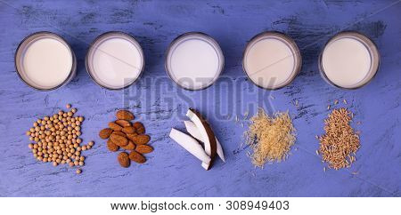 Types Of Vegetable Milk, Organic, In Glasses On The Blue Stone Table. View From Above