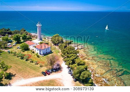 Savudrija Lighthouse And Turquoise Crystal Clear Rocky Beach Aerial View, Westernmost Point Of Croat