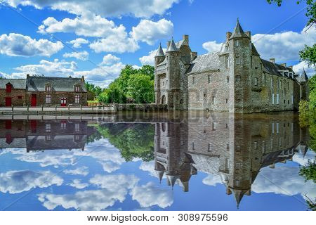 French Brittany Village On A Sunny Day. Clastle Reflect In The Lake. France