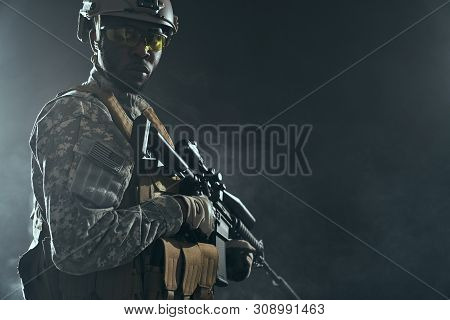 View From Clouds Of Smoke On American Ranker With Armour Confidently Standing With Weapon And Lookin