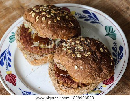 Close Up View Of Fresh Tasty Vegetarian Soja Hamburger On Plate On Wooden Background. The Burger Has