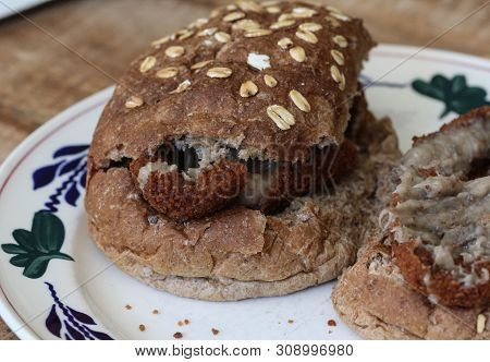 Close Up Of A Kroket On Bun On A Plate