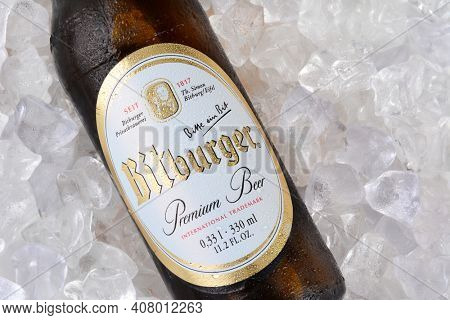 IRVINE, CA - JANUARY 11, 2015: A closeup of a bottle of Bitburger Beer on a bed of ice. Bitburger is a German family business with around  that in 2012 produced around 750 million litres of beer.