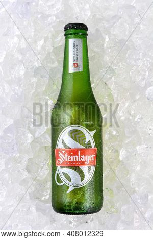 IRVINE, CA - JANUARY 11, 2015: A full length bottle of Steinlager Classic on a bed of ice. The lager style beer has been produced by Lion Nathan since 1957 in Newmarket, New Zealand.