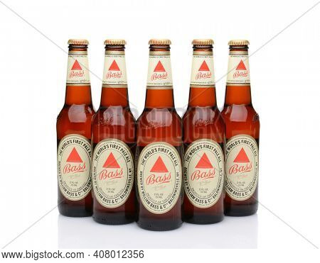 IRVINE, CA - MAY 25, 2014: Five bottles of Bass Ale on white. The Bass Brewery was founded in 1777 by William Bass, in Trent, England is now owned by Anheuser-Busch InBev.