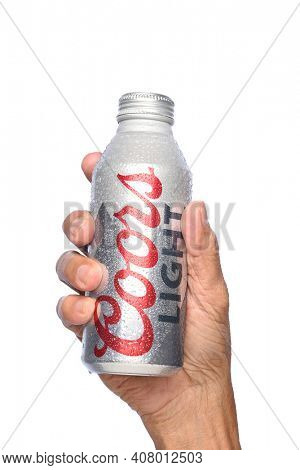 IRVINE, CALIFORNIA - APRIL 26, 2019: Closeup of a hand holding a Coors Light Aluminum Pint Bottle with condensation.
