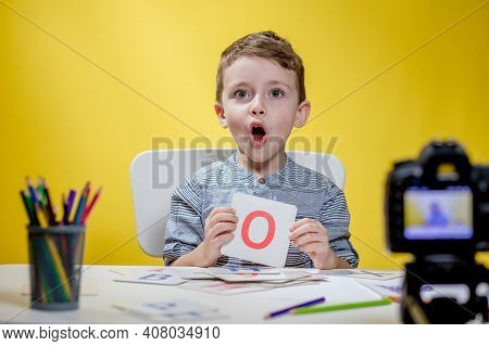 Beautiful Little Blogger Bloging About Learning The Alphabet On Yellow Background. Back To School. D