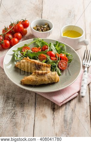 rolled sword fish with capers arugula and tomatoes salad