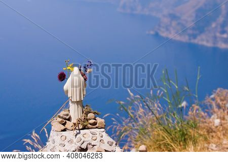 A Small Statue Of Mary That Overlooks The Sea From High Up On The Path Of The Gods On The Amalfi Coa