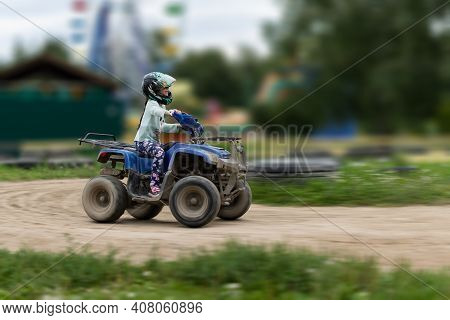 A Child Rides An Atv On The Track