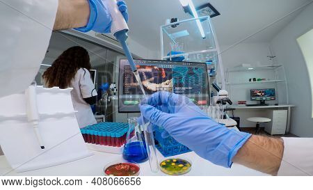 Fpv Of Scientist Using Micropipette For Filling Test Tube With Liquid, Conducting Chemical Experimen