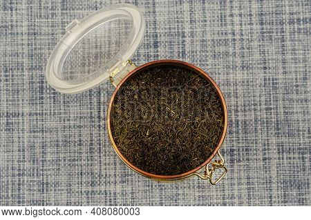 Flat Lay Open Tea Coffee Tin With Latch. Latch Lock Tin With Dried Tea Leaves. Sele