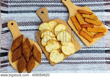 Different Types Croutons On Wooden Boards Close-up, White, Brown, Dark