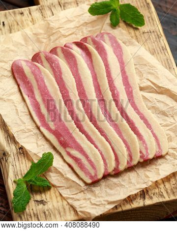 Raw Plant Based Vegan Bacon Pieces On Crumpled Paper