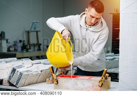 Worker Pouring Gypsum Plaster In Open Form For Mold Casting For Making Tableware