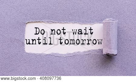 The Text Do Not Wait Until Tomorrow Appears On Torn Lilac Paper Against A White Background.