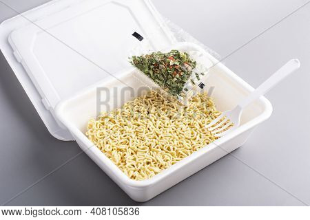 Instant Chinese Noodles With Spices On Grey Background. Asian Fast Food, Junk Food, Unhealthy Food. 