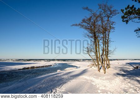 Snow Covered Beach On The Baltic Sea. Piasnica River, Debki, Poland