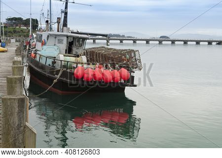 Riverton New Zealand - February 27 2015; Fishing Boat With Bright Pink Buoys Tied To Stern Rail At P