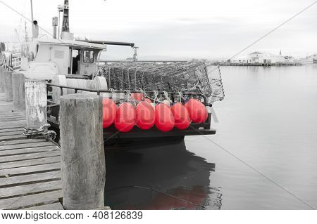 Monochrome Industrial Image With Spot Color Fishing Boat With Bright Pink Buoys Tied To Stern Rail A