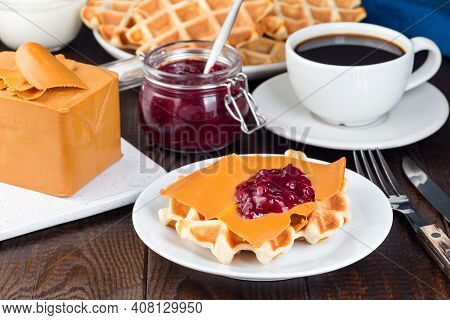 Homemade Waffles With Norwegian Brown Cheese And Lingon Jam, On A Wooden Background, Horizontal