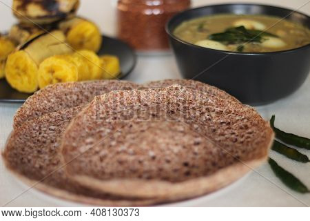 Hoppers Made Of Finger Millet Served With Egg Stew Prepared In Kerala Style And Steamed Plantain.