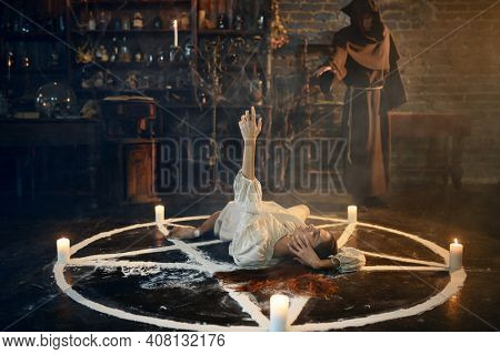 Exorcist casting out satan from creepy woman