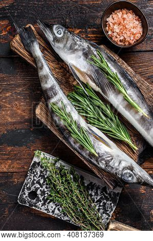 Whole Fresh Raw Icefish On A Wooden Cutting Board. Wooden Background. Top View