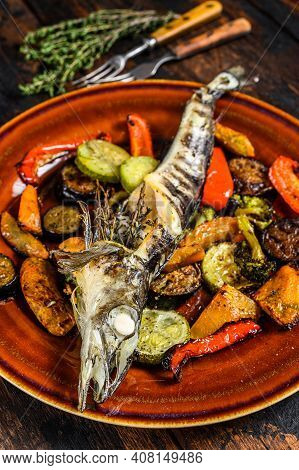 Baked Whole Icefish With Grilled Vegetables. Dark Wooden Background. Top View