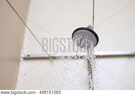 Water Flowing From An Old Shower Head With Ceramic Handle With Limescale Needed To Be Replaced Or De