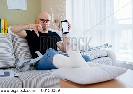 Dissatisfied Man With A Broken Leg In A Cast. He Didnt Receive Any Insurance Compensation.