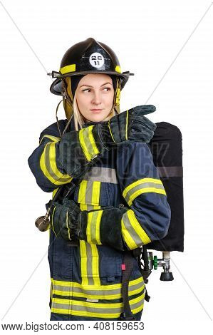 Young Caucasian Woman In Uniform Of Fireman Posing In Profile With Air Tank On Her Back And Pointing