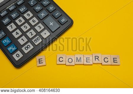 Phrase Or Word - E-comerce. Wooden Block Letter Word And Modern Calculator On A Yellow Background, B