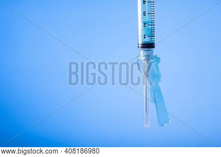 Syringe On Blue Background. Vaccine Preventions. Detail. Copy Space