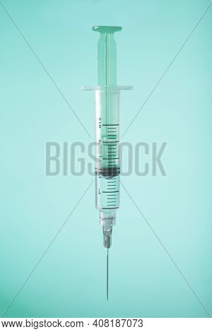 Syringe On Green Background. Vaccine Preventions. Copy Space