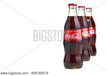 Estonia, Tallinn - 14.02.2021: Coca-cola Classic In A Glass Bottle Isolated On White. Single Glass B