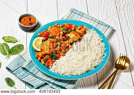 Chicken And Chickpea Curry Served With Jasmine Rice With Cherry Tomatoes, Baby Spinach, Yellow Curry