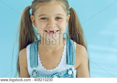Portrait Of Preschooler Girl With Open Mouth Without Milk Tooth. High Quality Photo