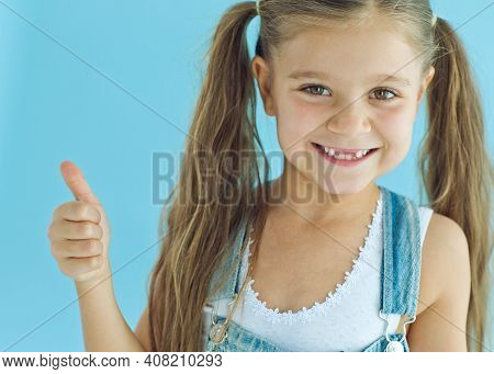 Portrait Of Preschooler Girl With Open Mouth Without Milk Tooth. High Quality Photo