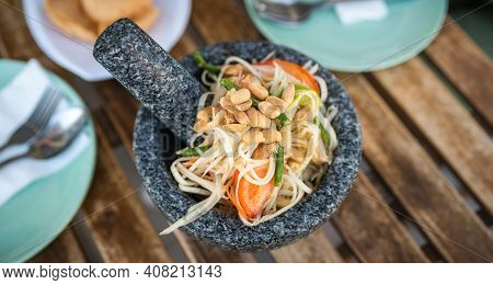 Thai Green Papaya Salad Called Som Tam Or Som Dam On A Plate Top View