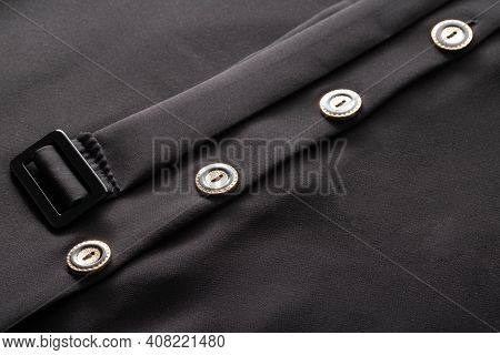 Black Stylish Clothes With Buttons And A Belt, Background. Dress For Woman, Macro, Material